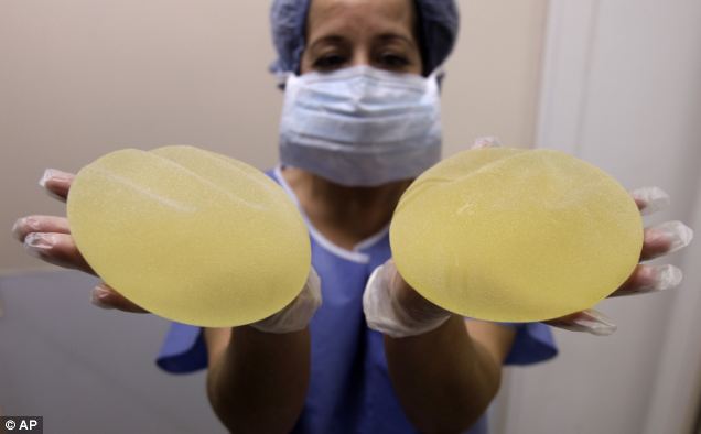 A nurse holds defective breast implant manufactured by French company Poly Implant Prothese (PIP)